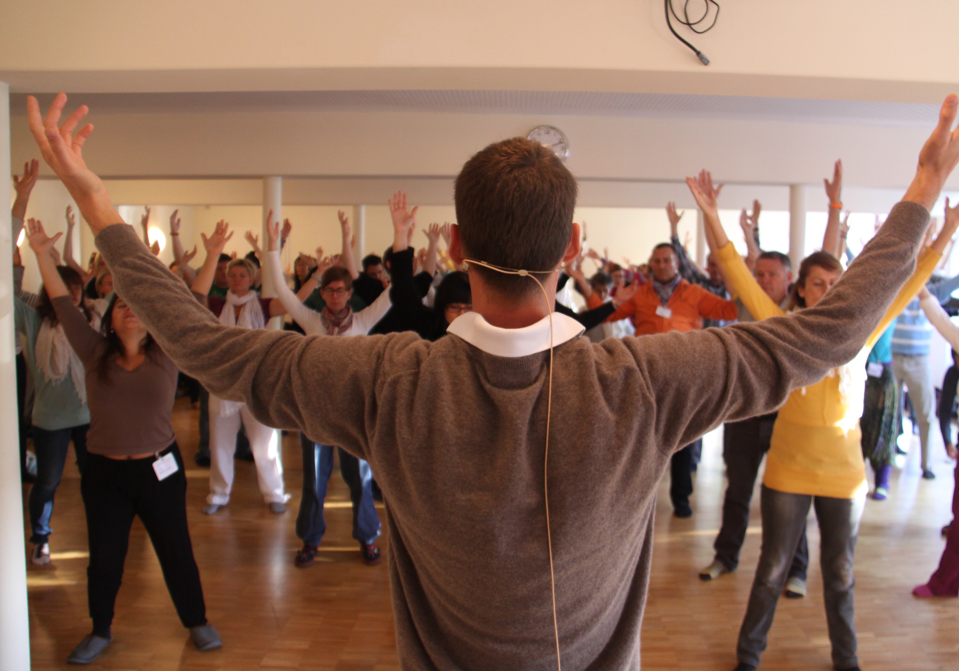 an Energy Balancing class with class members' arms raised in the air